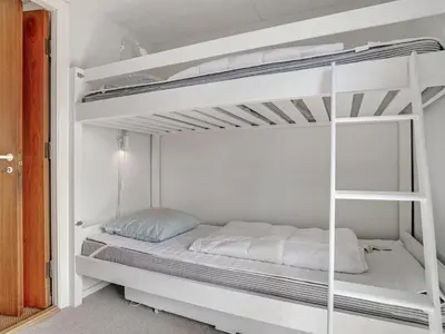 a white bunk bed in a white room at Holiday Home Tayanita - 750m from the sea by Interhome in Torsted
