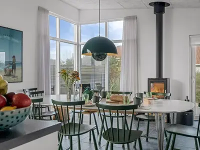 a dining room with a table and chairs at Holiday Home Pontus - 400m from the sea by Interhome in Torsted