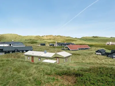 a group of houses in a field with a kite at Holiday Home Stener - 250m from the sea by Interhome in Torsted