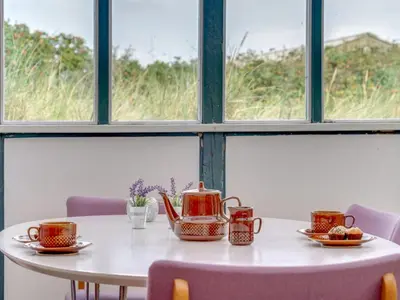 a table with four tea pots and plates on it at Holiday Home Stener - 250m from the sea by Interhome in Torsted