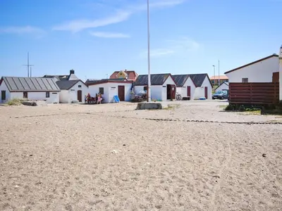 a row of houses on a beach with a dirt road at Holiday Home Stener - 250m from the sea by Interhome in Torsted