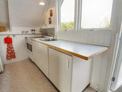 a small kitchen with a sink and a window at Holiday Home Algonda - 500m from the sea by Interhome in Torsted