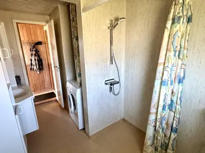 a shower in a bathroom with a shower curtain at Holiday Home Bera - 250m from the sea by Interhome in Torsted