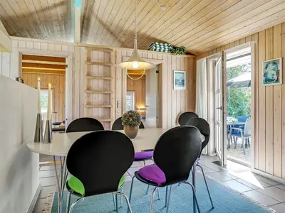 a dining room with a table and chairs at Holiday Home Aslak - 350m from the sea by Interhome in Torsted