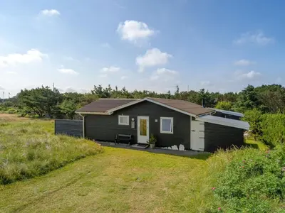 a small house in a field with a yard at Holiday Home Vuokko - 400m from the sea by Interhome in Torsted