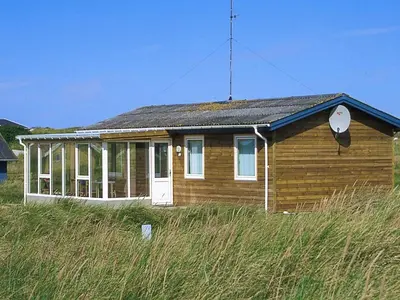 a small house on the side of a field at Holiday Home Gisela - 250m from the sea by Interhome in Torsted