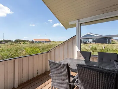 a patio with a table and chairs on a deck at Holiday Home Milena - 600m from the sea by Interhome in Torsted