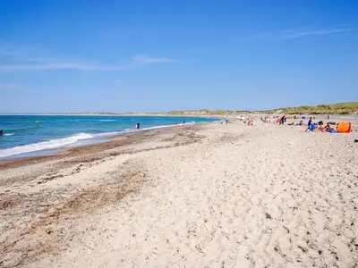 a group of people walking on a beach at Holiday Home Afke - 900m from the sea by Interhome in Torsted