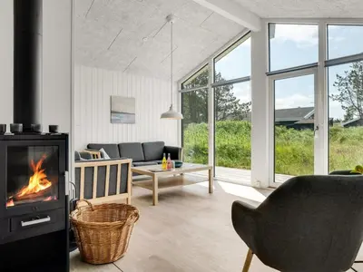 a living room with a fireplace and a couch at Holiday Home Raakel - 950m from the sea by Interhome in Torsted
