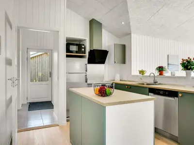 a kitchen with a bowl of fruit on a counter at Holiday Home Raakel - 950m from the sea by Interhome in Torsted