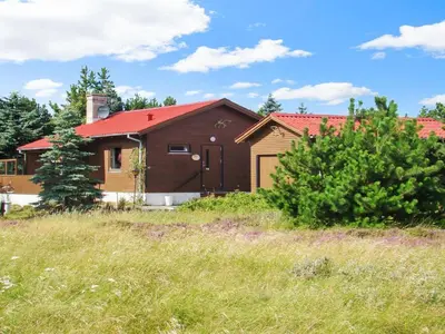 a house with a red roof in a field at Holiday Home Eine - 800m from the sea by Interhome in Torsted