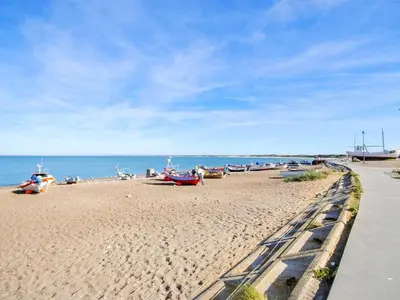 a beach with boats on the sand and the water at Holiday Home Majgull - 150m from the sea by Interhome in Torsted