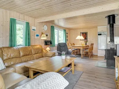 a living room with a couch and a table at Holiday Home Hughlek - 900m from the sea by Interhome in Torsted