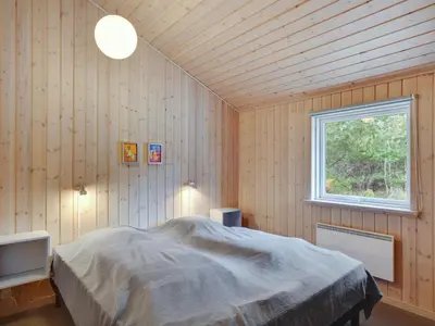a bedroom with a bed in a room with a window at Holiday Home Anegrete - 900m from the sea by Interhome in Torsted