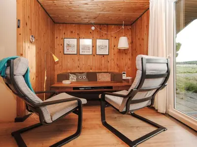 two chairs in front of a desk in a room at Holiday Home Tuovi - 800m from the sea by Interhome in Torsted