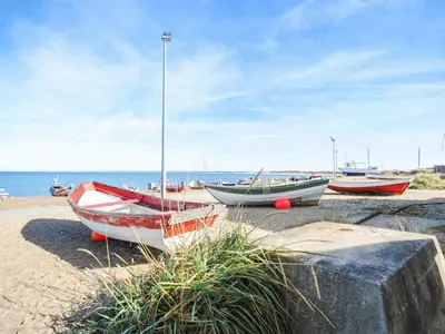 a group of boats sitting on the beach at Holiday Home Mavis - 800m from the sea by Interhome in Torsted