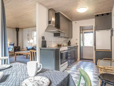 a kitchen with stainless steel appliances and a living room at Holiday Home Lökea - 800m from the sea by Interhome in Torsted