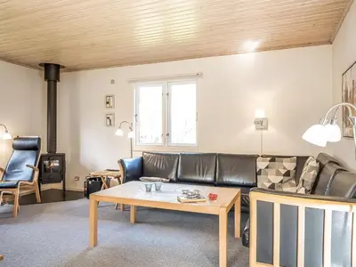 a living room with a couch and a table at Holiday Home Lökea - 800m from the sea by Interhome in Torsted