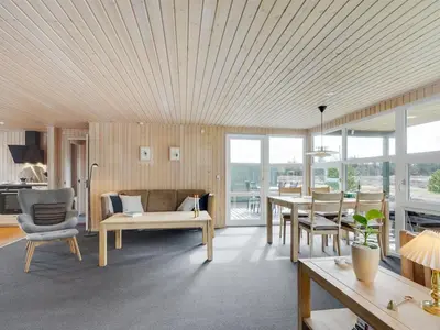 a living room with a couch and a table at Holiday Home Asmir - 1-1km from the sea by Interhome in Torsted