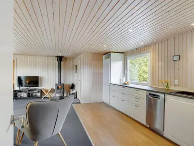 a kitchen with a table and a chair in a room at Holiday Home Asmir - 1-1km from the sea by Interhome in Torsted