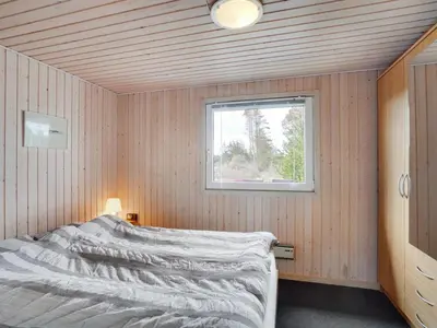 a bedroom with a bed and a window at Holiday Home Asmir - 1-1km from the sea by Interhome in Torsted