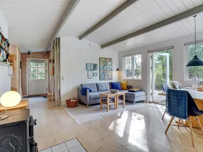 a living room with a couch and a table at Holiday Home Pilvi - from the sea by Interhome in Torsted