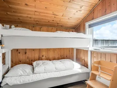 a bedroom with two bunk beds and a window at Holiday Home Luzy - 600m from the sea by Interhome in Torsted