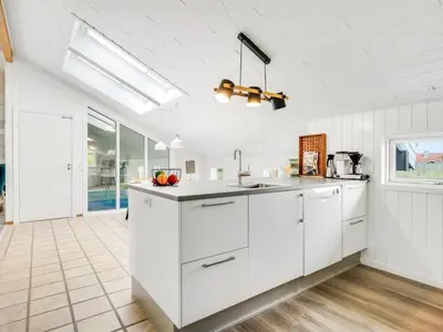 a kitchen with white cabinets and a counter top at Holiday Home Luzy - 600m from the sea by Interhome in Torsted