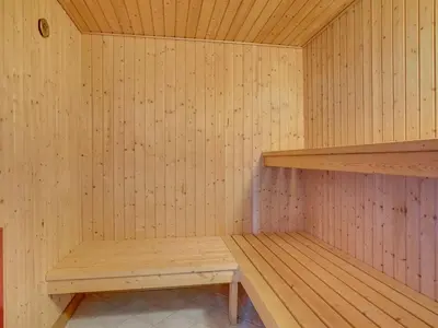 a empty sauna with a wooden bench in it at Holiday Home Bodulf - 600m from the sea by Interhome in Torsted