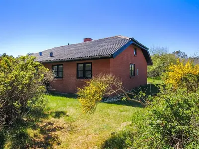 a red brick house with a black roof at Holiday Home Duco - 300m from the sea by Interhome in Torsted