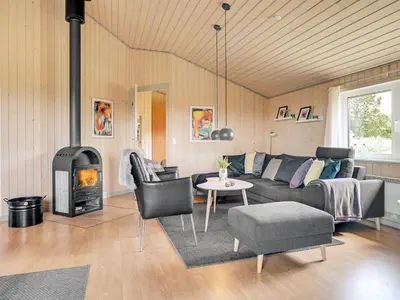 a living room with a couch and a fire place at Holiday Home Ivar - 900m from the sea by Interhome in Torsted