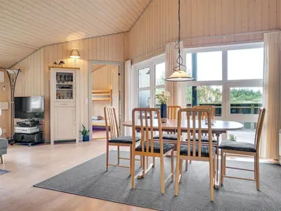 a dining room with a table and chairs at Holiday Home Ivar - 900m from the sea by Interhome in Torsted