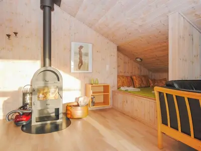 a room with a stove in a room with a bed at Holiday Home Laurentia - 800m from the sea by Interhome in Torsted