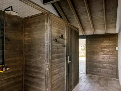 a room with a wooden wall and a door at Holiday Home Hornbogi - 300m from the sea by Interhome in Torsted