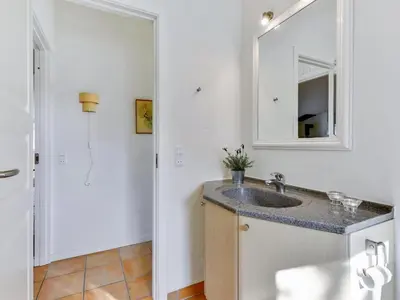 a bathroom with a sink and a mirror at Holiday Home Vivina - 250m from the sea by Interhome in Torsted
