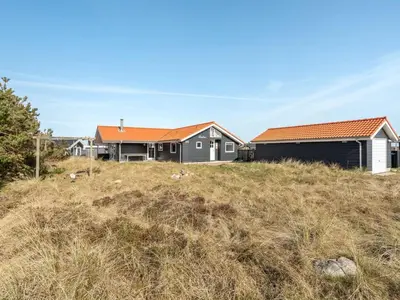 a house with an orange roof on top of a field at Holiday Home Øde - 350m from the sea by Interhome in Torsted