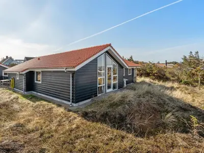 a small house sitting on top of a field at Holiday Home Øde - 350m from the sea by Interhome in Torsted