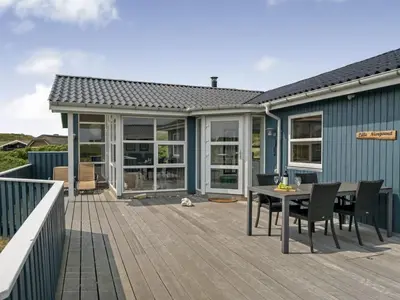 a patio with a table and chairs on a deck at Holiday Home Fabiana - 350m from the sea by Interhome in Torsted