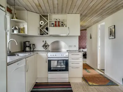 a kitchen with white cabinets and a stove at Holiday Home Fabiana - 350m from the sea by Interhome in Torsted