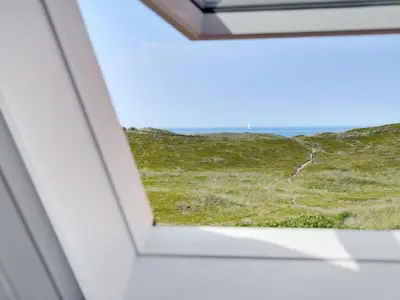 a window in a house with a view of the ocean at Holiday Home Bernice - 150m from the sea by Interhome in Torsted