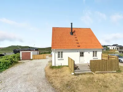 a small white house with an orange roof at Holiday Home Bernice - 150m from the sea by Interhome in Torsted