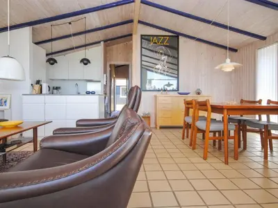 a kitchen and dining room with a table and chairs at Holiday Home Jerrik - 900m from the sea by Interhome in Torsted