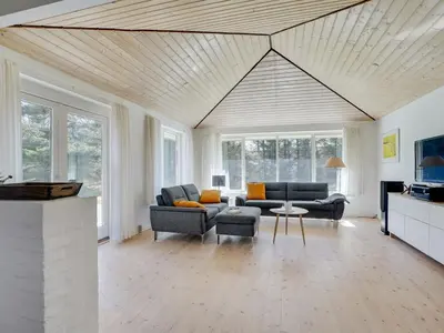 a living room with two couches and a tv at Holiday Home Örjan - 400m from the sea by Interhome in Torsted