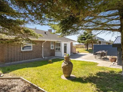 a large vase in the yard of a house at Holiday Home Örjan - 400m from the sea by Interhome in Torsted