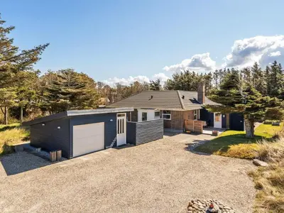 a house with a garage and a driveway at Holiday Home Örjan - 400m from the sea by Interhome in Torsted
