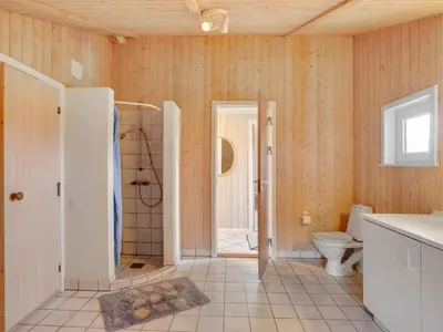 a bathroom with a shower and a toilet at Holiday Home Rosali - 500m from the sea by Interhome in Torsted