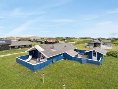 an overhead view of a blue house in a field at Holiday Home Joern - 300m from the sea by Interhome in Torsted