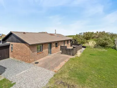 a brick house with a patio and a yard at Holiday Home Fridolina - 200m from the sea by Interhome in Torsted