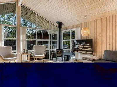 a living room with a couch and chairs and a fireplace at Holiday Home Ansfried - 900m from the sea by Interhome in Torsted
