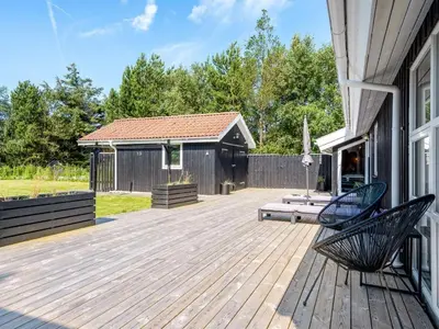 a deck with two chairs on a house at Holiday Home Ansfried - 900m from the sea by Interhome in Torsted